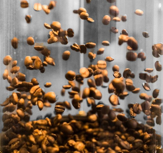 Roasted beans are shown floating around. 